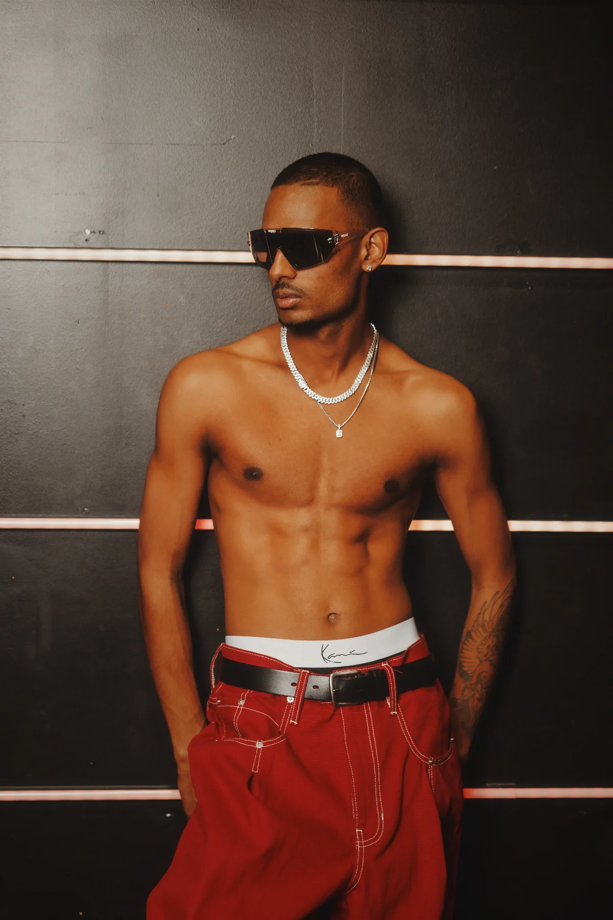 NIJO shot by Calvin G — Karl Kani waistband detail with Red Canvas trousers