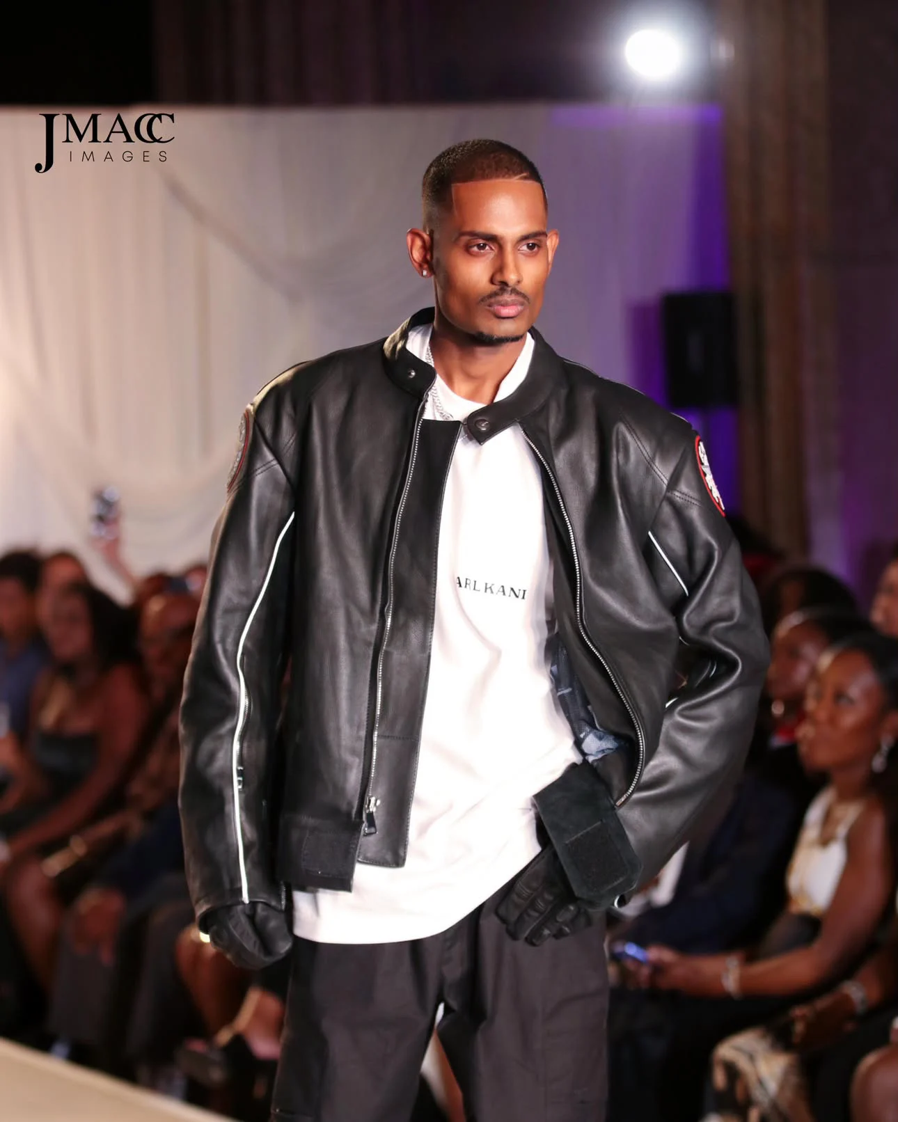NIJO walking the Karl Kani show at New York Fashion Week 2026 in a black KK Racing leather jacket