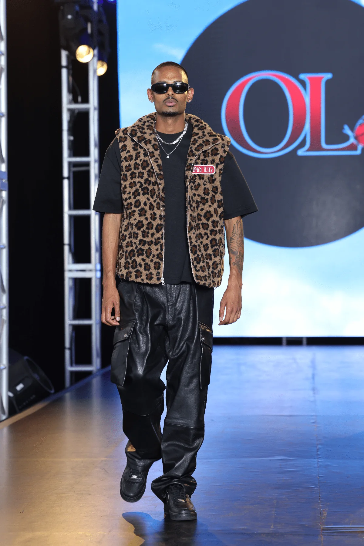 NIJO walking the NYFW Festival runway for Odd Life — full look, Odd Life logo on screen